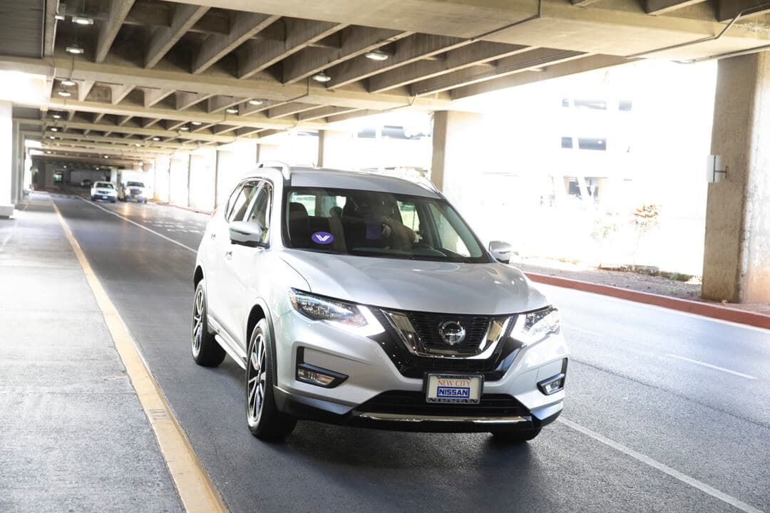 A rental car with the GoVibe logo arrives for an airport pick-up