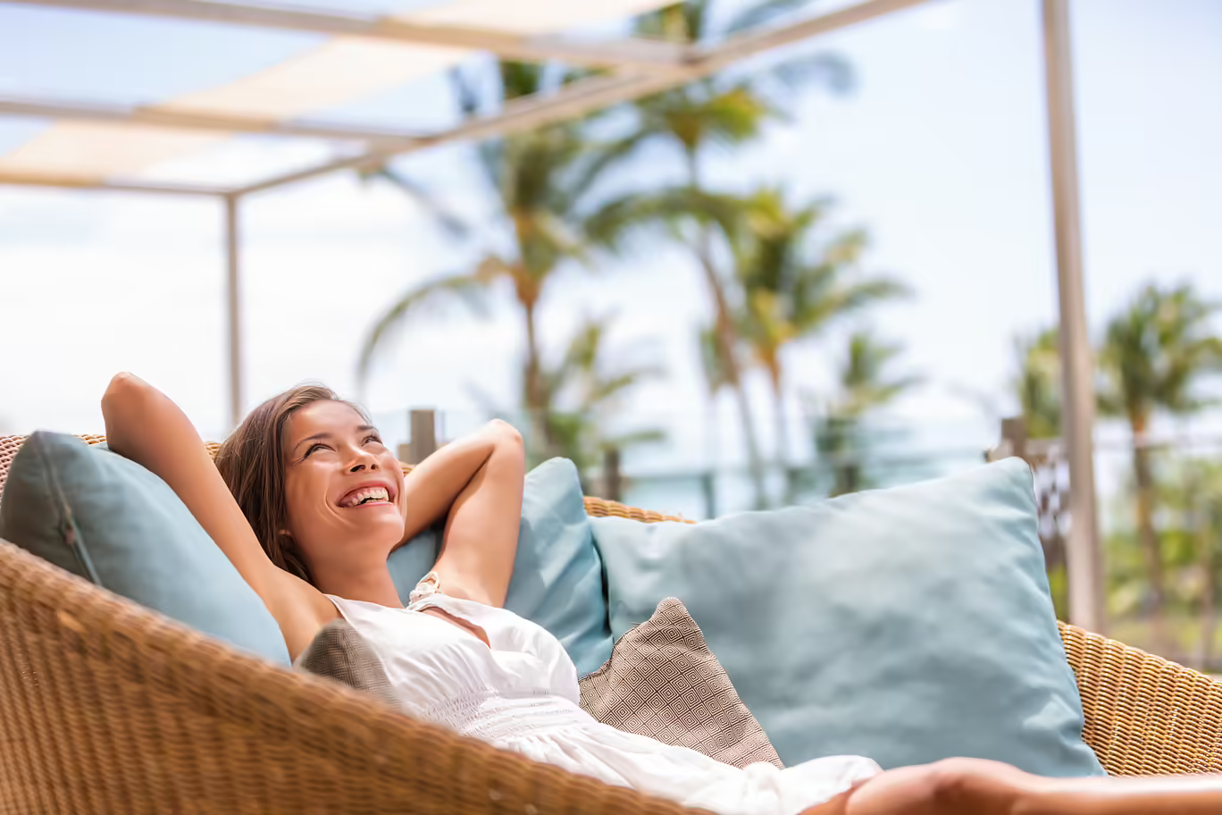 A woman relaxing outdoors near palm trees