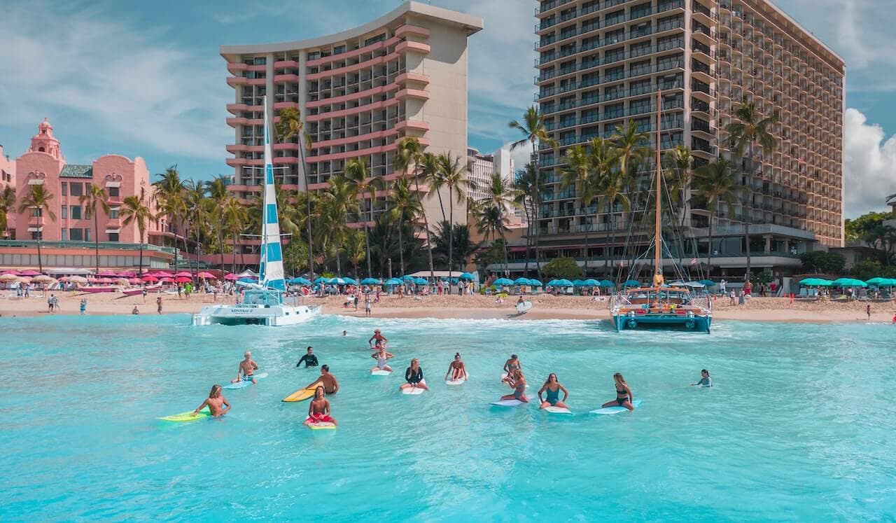 People swimming in front of a hotel on a Hawai'i vacation from Salt Lake City